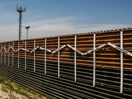 Mexico–United States barrier at the border of Tijuana, Mexico and San Diego, USA. The crosses represent migrants who died in the crossing attempt. Some identified, some not. Surveillance tower in the background.