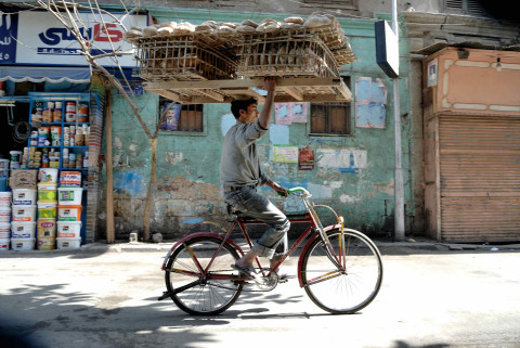 Man on bicycle with bread