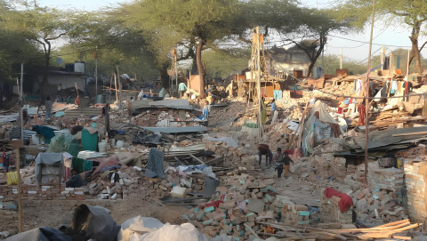 People in the ruins of their homes in South Delhi, 2012