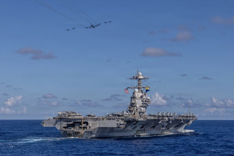 Carrier Air Wing 8 F/A-18E Super Hornets and a U.S. Air Force B-52H Stratofortress fly over the world’s largest aircraft carrier, Ford-class aircraft carrier USS Gerald R. Ford (CVN 78) in the western Atlantic Ocean, Nov. 13, 2025. 