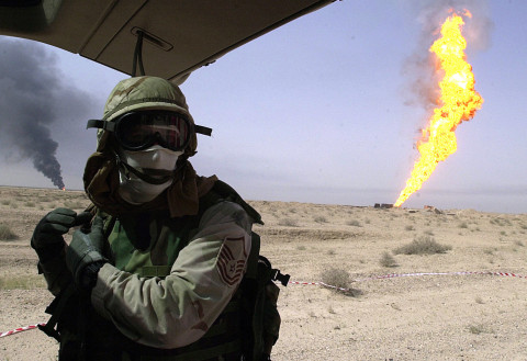 US soldier in Iraq. US soldier in Iraq near natural-gas fire in the Rumaylah oil fields in southern Iraq.