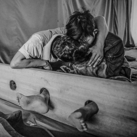 A staff member coaxes information from a drug user at a drug rehabilitation center in Kachin State, Myanmar