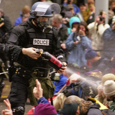 WTO protests in Seattle, November 30, 1999 Pepper spray is applied to the crowd.