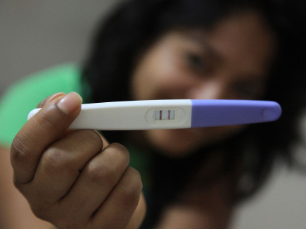 Woman with pregnancy test