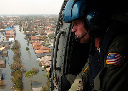 A number of survivors were shot by police and the military in the wake of Hurricane Katrina in the midst of racist media hysteria about looting. Photo of coastguard overlooking flooded New Orleans