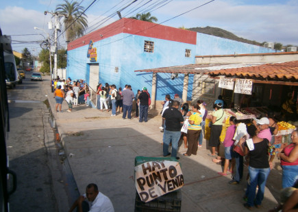 Shoppers waiting in line at a government-run MERCAL store.