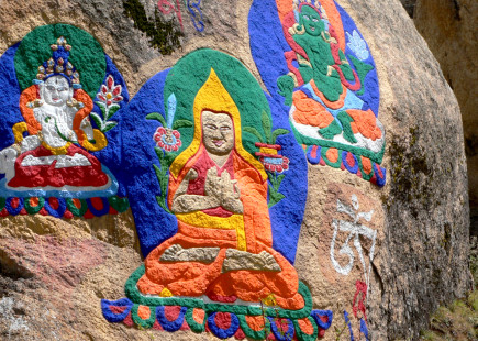 Traditional Buddhist images painted on rocks in Tibet