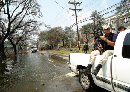 A caravan of various security forces cruises through the flooded streets of the 9th Ward distrtict of New Orleans, in the aftermath of Hurricane Katrina. 