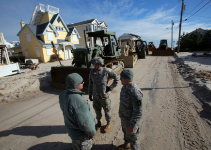 Soldiers from the 150th and 160th Engineer Companies, New Jersey Army National Guard, discuss movement options for their D7 bulldozers prior to performing beach replenishment operations Nov. 8, 2012. The photo shows the devastated Holgate section of Long Beach Island, N.J., following Hurricane Sandy and Nor’easter Athena