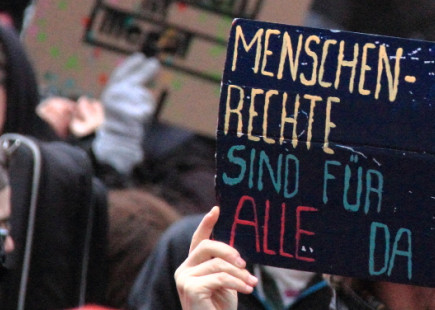 Sign reads "Human Rights are for all" at demonstration in Hamburg on November 14, 2015
